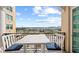 A private balcony boasts scenic views of the surrounding city, complete with cozy seating for relaxation at 750 N Tamiami Trl # 814, Sarasota, FL 34236