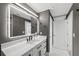 A modern bathroom features a sleek vanity with black hardware, a well-lit mirror, and neutral tones at 750 N Tamiami Trl # 814, Sarasota, FL 34236