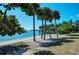 Beautiful waterfront property with private sandy beach and swaying palm trees offering serene coastal living at 750 N Tamiami Trl # 814, Sarasota, FL 34236