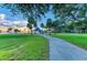 Scenic community park with walking path, lush grass, a gazebo and palm trees create inviting outdoor space at 750 N Tamiami Trl # 814, Sarasota, FL 34236