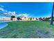 Expansive community park featuring a large grassy lawn, walking path, trees, and waterfront views at 750 N Tamiami Trl # 814, Sarasota, FL 34236