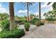 Lush courtyard with mature palm trees, manicured hedges and a small garden in an upscale community at 750 N Tamiami Trl # 814, Sarasota, FL 34236