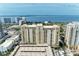 Beautiful facade of a yellow high-rise building featuring numerous balconies with expansive ocean views at 750 N Tamiami Trl # 814, Sarasota, FL 34236