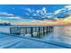 Picturesque view of a fishing pier with a concrete walkway and waterfront views of the city at 750 N Tamiami Trl # 814, Sarasota, FL 34236