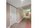 Long hallway with designer carpet and elegant wallpaper leads to a residential unit at 750 N Tamiami Trl # 814, Sarasota, FL 34236