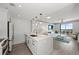 Open kitchen featuring white cabinets, a marble countertop, and a seamless view into the living room at 750 N Tamiami Trl # 814, Sarasota, FL 34236
