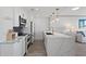 Well-appointed kitchen with stainless steel appliances, marble countertop, and adjacent living area with a view at 750 N Tamiami Trl # 814, Sarasota, FL 34236