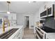 Sleek, modern kitchen boasting white cabinets, stainless steel appliances, and a stylish gold faucet at 750 N Tamiami Trl # 814, Sarasota, FL 34236