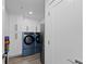 A functional laundry room features a front-load washer and dryer, stainless steel fridge, and ample storage at 750 N Tamiami Trl # 814, Sarasota, FL 34236