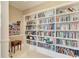Spacious home library featuring extensive built-in bookshelves filled with books at 750 N Tamiami Trl # 814, Sarasota, FL 34236