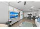 Open-concept living space with a modern kitchen, a large screen tv, and comfortable seating at 750 N Tamiami Trl # 814, Sarasota, FL 34236