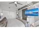A well-lit bedroom has a large closet, a mounted TV, and neutral tones for a serene atmosphere at 750 N Tamiami Trl # 814, Sarasota, FL 34236
