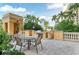 Community outdoor kitchen with lush plants, a grill, and seating at 750 N Tamiami Trl # 814, Sarasota, FL 34236