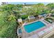 Luxurious pool and hot tub area with an elevated view of lush landscapes and sparkling waters at 750 N Tamiami Trl # 814, Sarasota, FL 34236