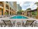 Stunning outdoor pool with lounge chairs, pergolas, and a sunny deck for relaxation at 750 N Tamiami Trl # 814, Sarasota, FL 34236