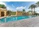 Inviting community swimming pool area surrounded by palm trees and comfortable lounge chairs at 750 N Tamiami Trl # 814, Sarasota, FL 34236