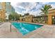 Resort-style pool area with comfortable lounge chairs and lush landscaping at 750 N Tamiami Trl # 814, Sarasota, FL 34236