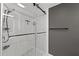 A modern bathroom offers a glass shower, a tiled shower base, and black hardware accents at 750 N Tamiami Trl # 814, Sarasota, FL 34236
