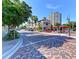 Charming street view with outdoor seating, lush trees, and colorful architecture creating a welcoming ambiance at 750 N Tamiami Trl # 814, Sarasota, FL 34236