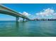 Expansive water view showcasing a bridge and cityscape under a bright blue sky with scattered clouds at 750 N Tamiami Trl # 814, Sarasota, FL 34236