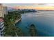 Picturesque waterfront view with lush trees, rock barriers, and the downtown cityscape at 750 N Tamiami Trl # 814, Sarasota, FL 34236