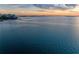 Expansive waterfront view showcasing clear water and a vibrant skyline in the distance at sunset at 750 N Tamiami Trl # 814, Sarasota, FL 34236