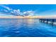 Stunning waterfront view of fishing pier with calm waters and colorful sunset sky at 750 N Tamiami Trl # 814, Sarasota, FL 34236