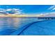Beautiful waterfront view featuring calm waters and a distant pier under a serene sky at 750 N Tamiami Trl # 814, Sarasota, FL 34236