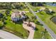Aerial view of a waterfront property with lush green landscaping and circular driveway at 766 Bayshore Dr, Terra Ceia, FL 34250
