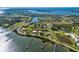 Expansive aerial view of waterfront homes, docks, and lush foliage near the bay at 766 Bayshore Dr, Terra Ceia, FL 34250
