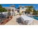 Beautiful backyard with a large pool, a dining table, and landscaped grounds perfect for entertaining at 766 Bayshore Dr, Terra Ceia, FL 34250