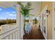 Covered balcony with comfortable chairs and views of the bay at 766 Bayshore Dr, Terra Ceia, FL 34250