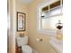 Clean and bright bathroom with frosted window, tiled shower, and white commode at 766 Bayshore Dr, Terra Ceia, FL 34250