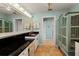 Stylish bathroom with granite countertops, a large mirror, and custom cabinetry for ample storage at 766 Bayshore Dr, Terra Ceia, FL 34250