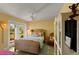 Comfortable bedroom with wicker furniture, ceiling fan, and sliding doors at 766 Bayshore Dr, Terra Ceia, FL 34250