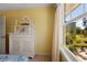 Bedroom featuring a window with bright natural light, a view to the back lawn, and a classic cabinet at 766 Bayshore Dr, Terra Ceia, FL 34250