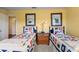 Charming bedroom featuring twin beds with nautical-themed decor and yellow walls at 766 Bayshore Dr, Terra Ceia, FL 34250