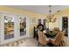 Inviting dining room with water views, a chandelier, and french doors leading to the outside at 766 Bayshore Dr, Terra Ceia, FL 34250