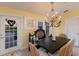 Cozy dining room with chandelier lighting and french doors leading to the outside at 766 Bayshore Dr, Terra Ceia, FL 34250