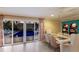 Bright dining room with a decorative table, woven chairs, and large glass doors leading to the pool at 766 Bayshore Dr, Terra Ceia, FL 34250