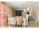 Bright dining room with rattan chairs and a turquoise hutch at 766 Bayshore Dr, Terra Ceia, FL 34250
