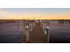 Waterfront dock with a boat lift featuring sunset views and ample space for relaxing and entertaining at 766 Bayshore Dr, Terra Ceia, FL 34250
