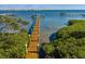 Tranquil view of a wooden dock extending into the calm bay water at 766 Bayshore Dr, Terra Ceia, FL 34250