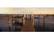 Waterfront dock with boat lifts and the open water at sunset at 766 Bayshore Dr, Terra Ceia, FL 34250