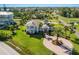 Stunning home with wraparound porches and a circular driveway amidst lush landscaping and mature palm trees at 766 Bayshore Dr, Terra Ceia, FL 34250
