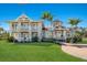Charming two-story house with a manicured lawn, brick pathway, and lush landscaping at 766 Bayshore Dr, Terra Ceia, FL 34250