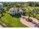 Stunning two-story waterfront home with lush landscaping and a circular driveway at 766 Bayshore Dr, Terra Ceia, FL 34250