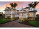 Charming home with meticulous landscaping, a brick path, and dual balconies at 766 Bayshore Dr, Terra Ceia, FL 34250