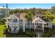 Charming coastal home with double balconies, a front porch, and lush, tropical landscaping at 766 Bayshore Dr, Terra Ceia, FL 34250