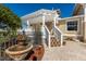 Charming home exterior with a pergola, fountain, lush landscaping, and welcoming stairs at 766 Bayshore Dr, Terra Ceia, FL 34250